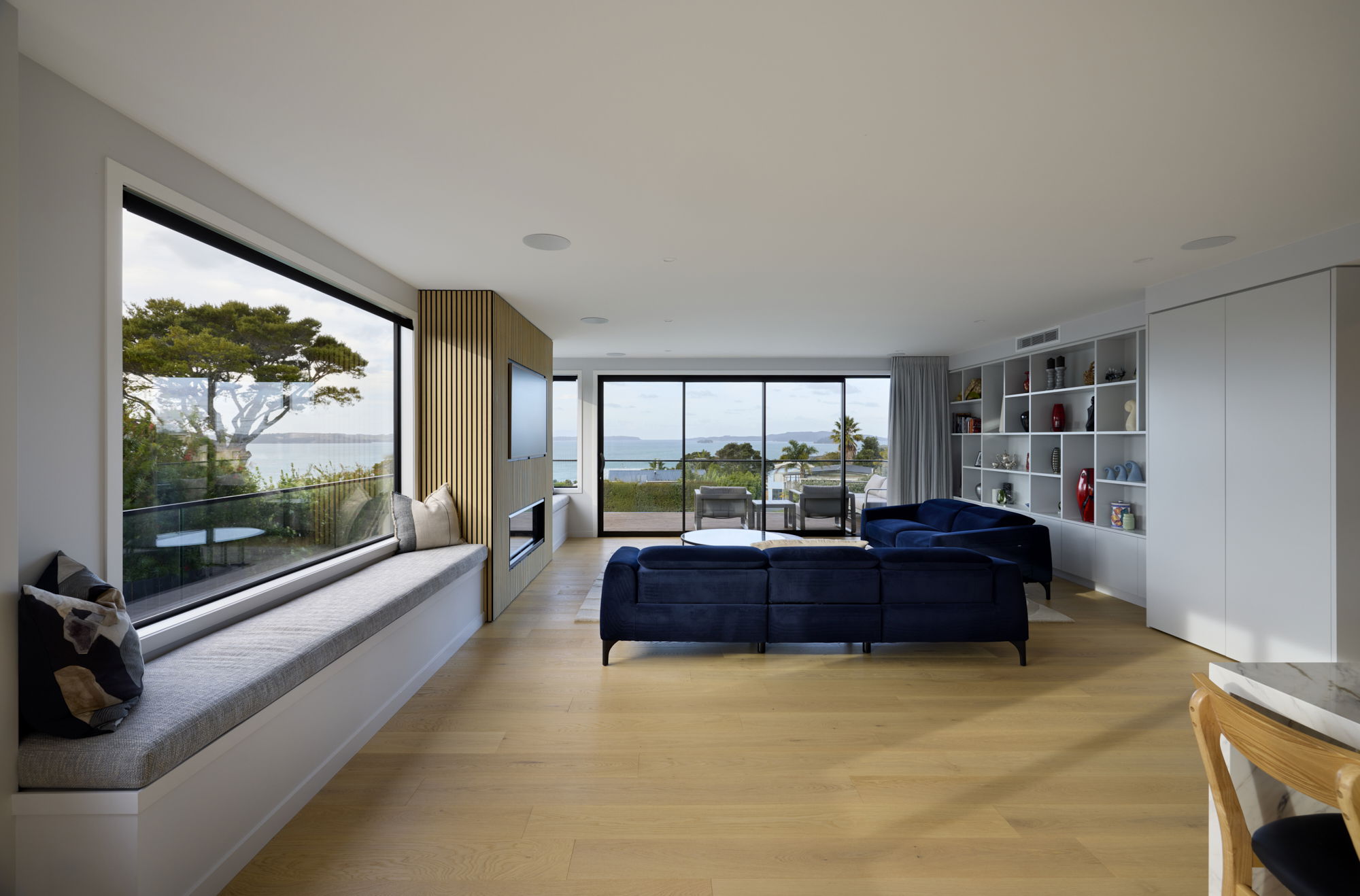 FMI Building Innovation vacuum insulated glass in large living room windows overlooking the coast
